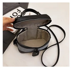 Detailed interior of the black and grey crossbody bucket bag with silver zipper
