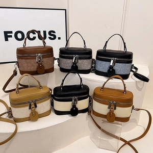 Mini vintage box bags in various colors featuring textured panels and top handles