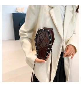 Gothic coffin-shaped crossbody bag with spider web pattern and silver studs