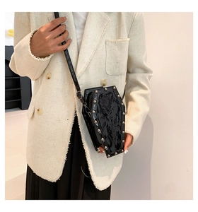 Detail of coffin-shaped crossbody bag with rose relief and silver metal studs