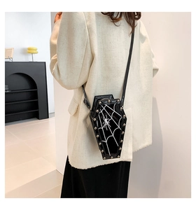 Gothic coffin-shaped crossbody bag featuring white spider web print and silver metal rivets