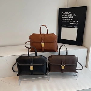 Structured vintage leather handbags in black, brown and tan with gold metal hardware
