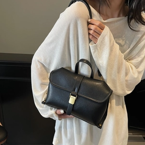 Retro black leather handbag with white contrast stitching and gold buckle for women