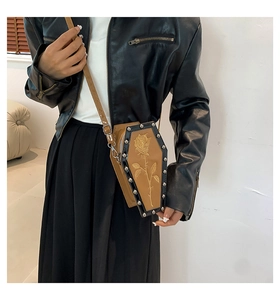 Gothic coffin-shaped crossbody bag with rose embroidery and stud details on a model