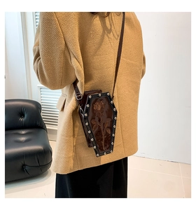 Detailed view of Gothic coffin-shaped crossbody bag with rose relief and silver studs