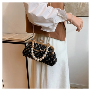 Fashionable black pleated evening clutch bag with gold sequins and pearl handle detail