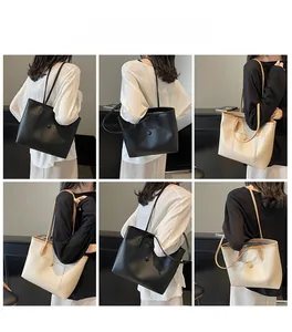 Model wearing black and cream large tote bags with minimalist matte leather finish