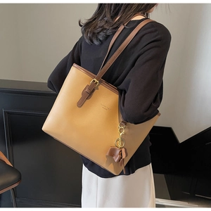 Detail of khaki PU leather tote bag with dark brown straps and Fashion Trend logo