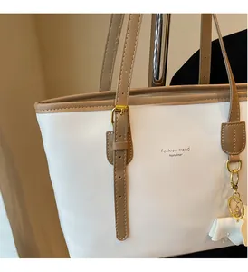 Close-up of vintage tote bag with gold-tone hardware and white bow charm detail