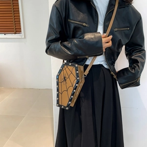 Gothic coffin-shaped crossbody bag with rivet details and spider web print on model