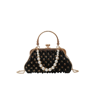 Pleated sequin shell bag with pearl handle and golden heart clasp in black
