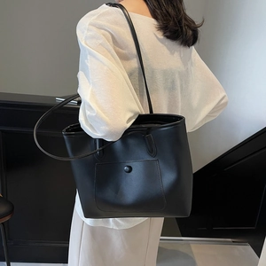 Minimalist black tote bag with outer pocket and round buckle for daily office commute