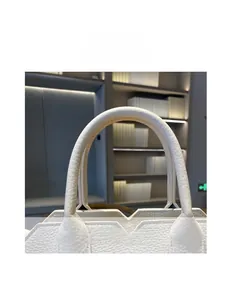 Detail view of the premium white lychee leather handle with refined stitching craftsmanship