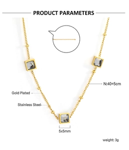 Detailed view of square gray crystal pendant on gold plated beaded stainless steel chain