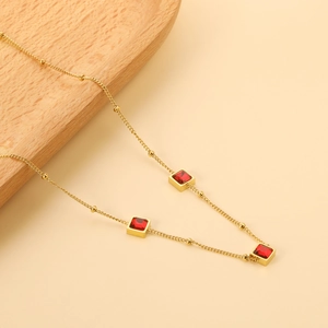 Gold stainless steel necklace with square red crystal pendants and beaded chain detail
