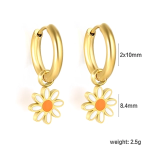 Detailed close-up of daisy drop earrings with gold hoops and white enamel petals