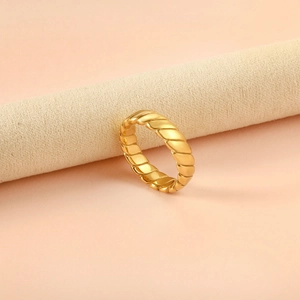 French style 18K gold plated twisted rope geometric ring on minimalist jewelry display