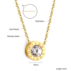 Macro view of gold plated stainless steel bow necklace with roman numeral ring pendant