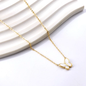 Macro view of 18K gold-plated bow necklace featuring elegant white mother-of-pearl inlay