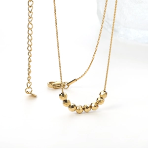 Gold stainless steel necklace with faceted geometric beads and adjustable lobster clasp
