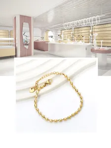 Detailed close-up of golden stainless steel wheat bead bracelet with lobster clasp