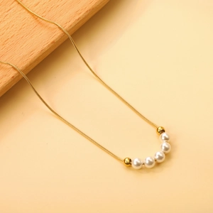 Elegant gold snake chain necklace featuring five white pearls and polished round beads