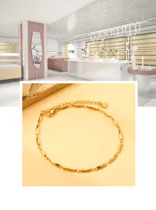 Detail view of 18K gold-plated stainless steel anklet with engraved heart pendant and lobster clasp