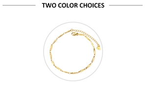 Detail of a golden stainless steel anklet with olive links and a heart charm