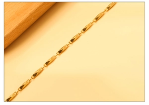 Detailed view of the gold-toned geometric multifaceted chain links and minimalist texture