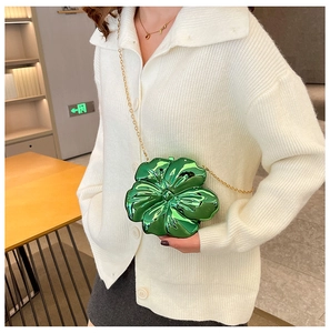 Detailed macro view of a 3D green flower-shaped mini bag with elegant gold chain strap