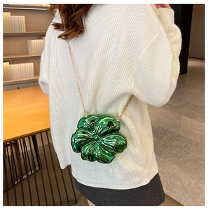 Detail view of the mini green floral crossbody bag with metallic finish and gold chain