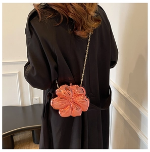 Chic rose gold flower crossbody bag with embossed texture shown on model's shoulder