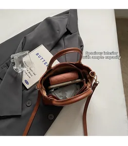 Top view of spacious interior of brown vintage bucket bag showing phone and wallet