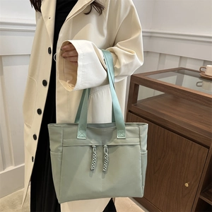 Minimalist light green large canvas tote bag with wide shoulder straps for daily commuting