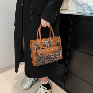 Vintage leopard print tote bag with brown handles and front gold zipper pocket