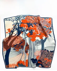 Detailed close-up of premium silk scarf featuring dark blue trees and orange leaves