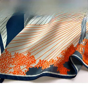 Detailed view of high-density stitching and hem on a printed pure silk square scarf