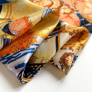 Macro shot of silk square scarf featuring artistic patterns and refined satin texture