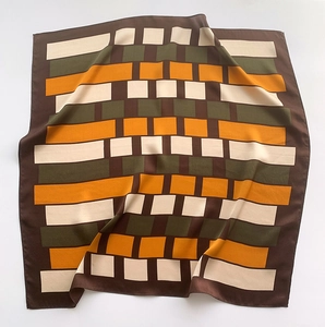 Detail of silk scarf with geometric color blocks in brown, orange, and olive green