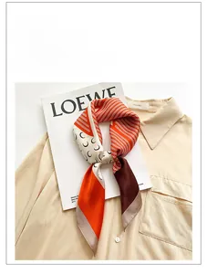 Detail of silk square scarf featuring geometric wave patterns and hand-rolled edges