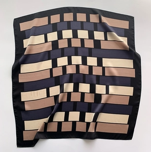 Detailed view of geometric plaid silk square scarf with modern neutral color blocking