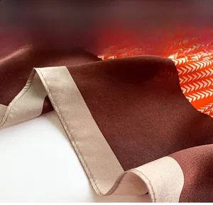 Detailed close-up of fine hemmed edges on a silk-textured scarf with herringbone pattern