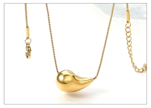 Detail of a polished gold teardrop pendant necklace with a fine box chain and lobster clasp