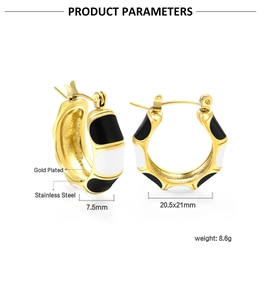 Detail of gold-plated bamboo texture C-shape earrings with black and white enamel finish