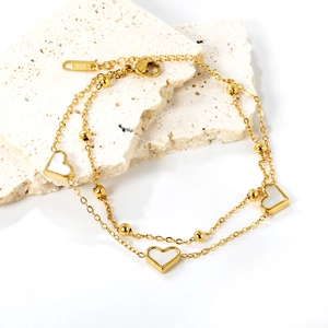 Bracelet double chaîne en or avec cœurs en nacre blanche sur socle en pierre