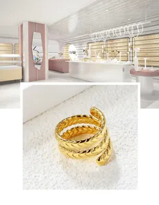 Detail showing the intricate woven texture of the golden 18K spiral multilayer ring