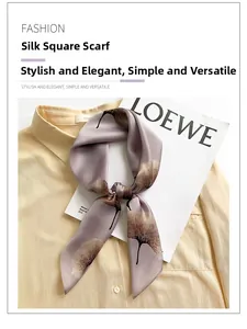 Detail of silk square scarf featuring brown ginkgo leaf patterns on light purple silk