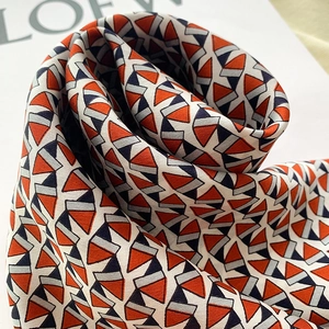 Detail of silk square scarf with geometric triangle print and soft satin luster finish