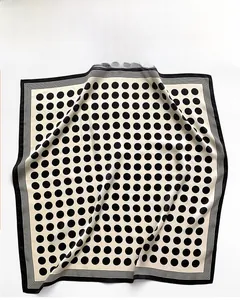 Detail of silk square scarf showing houndstooth pattern and botanical dyeing texture