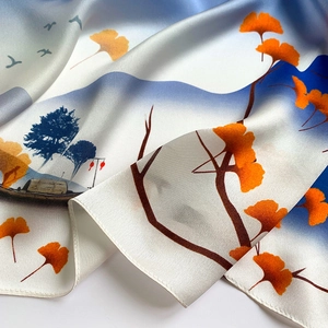 Detail showing smooth silk fabric texture with ginkgo leaf and landscape print